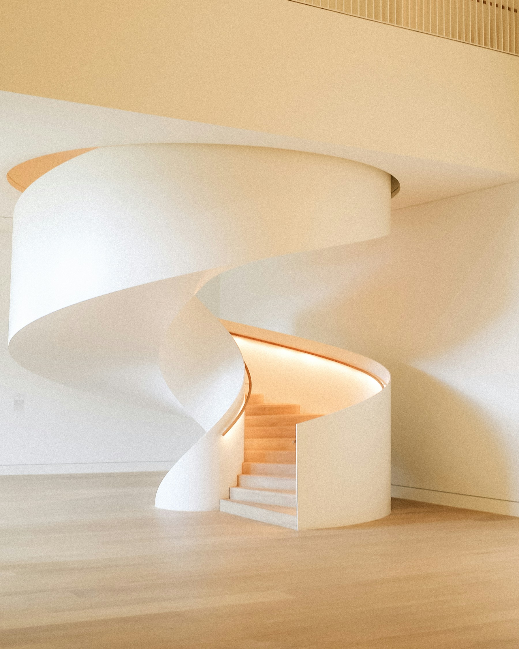 Modern white spiral staircase in an architectural interior